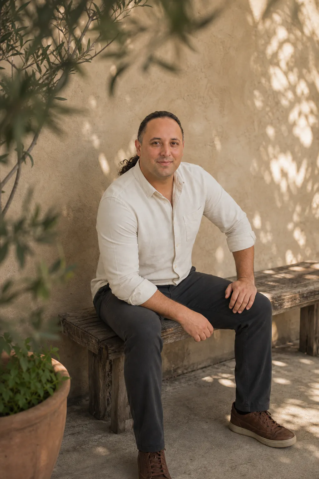 Loose Pooch founder Sina Vakili seated in a shaded California courtyard