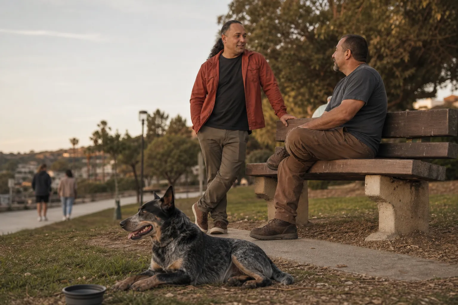 Sina Vakili speaking with a blue heeler's guardian in a quiet San Clemente park